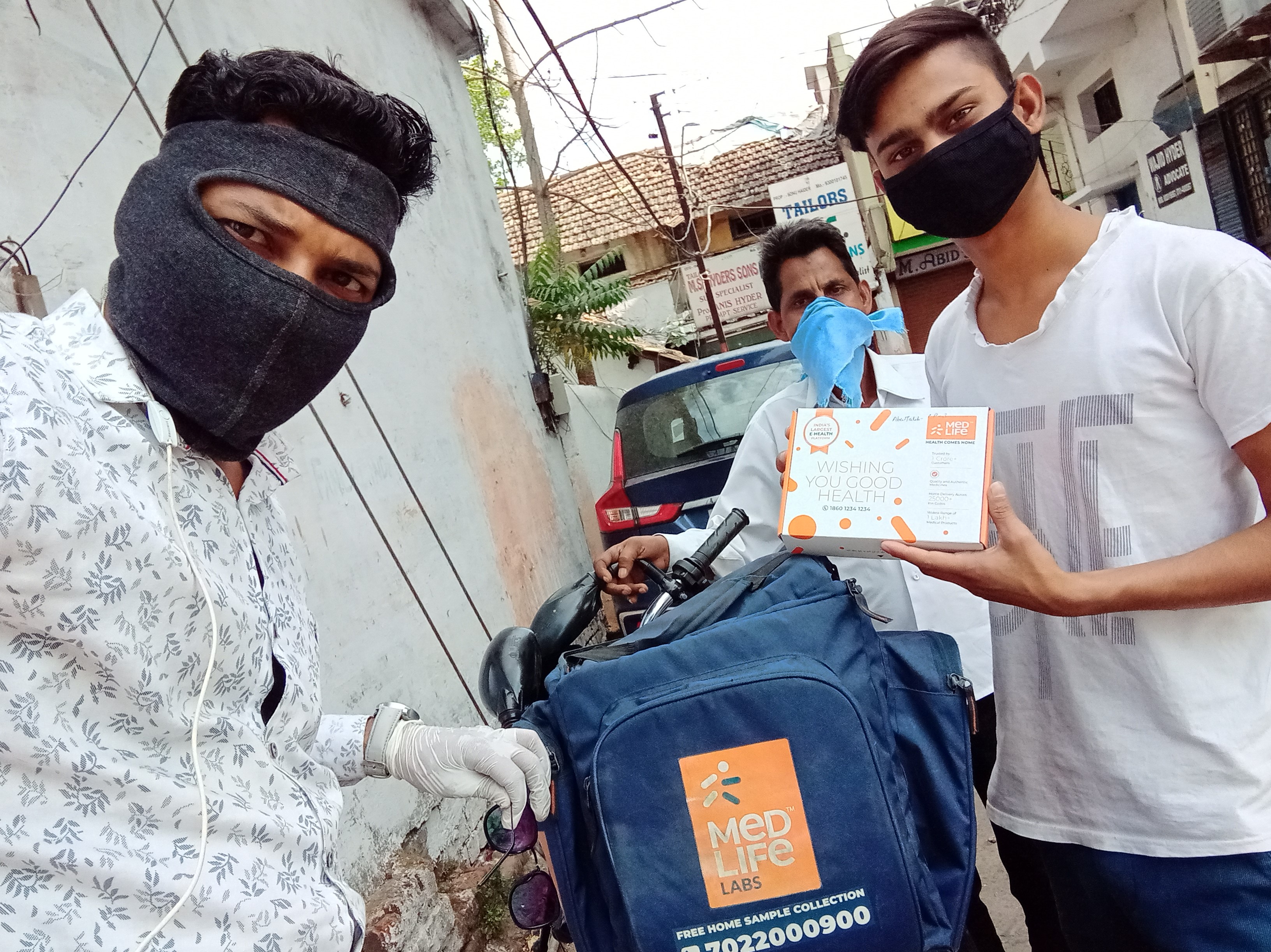 Man delivering medication while wearing a mask